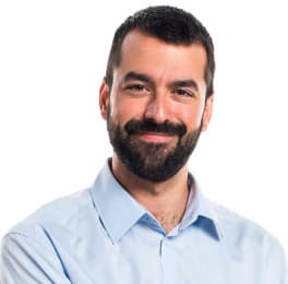 A smiling man with dark hair, a short haircut and a thick beard with a mustache